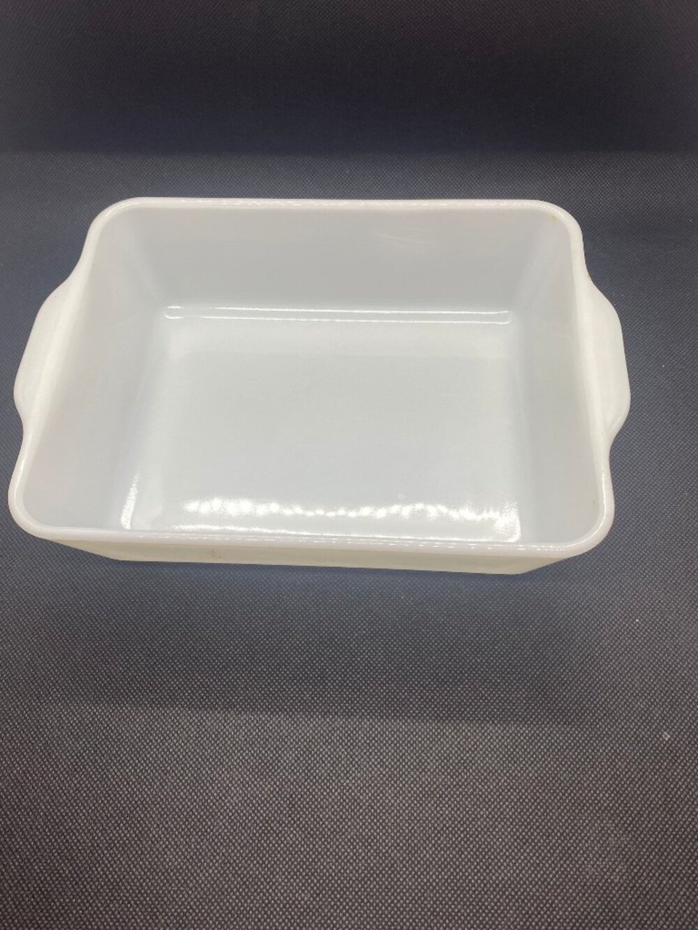 Pyrex White Casserole Dish. Only a small bit of the green design remains. 1 1/2